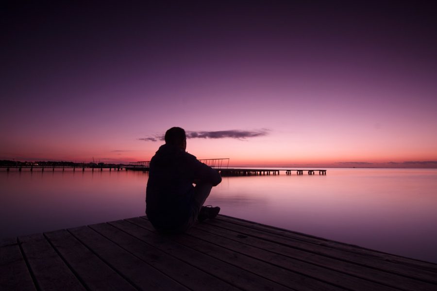 mindfulness recovery man on dock at sunset