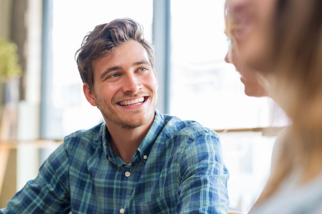 A man smiling during an addiction therapy group