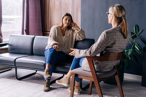 Woman listening to her therapist during mental health treatment