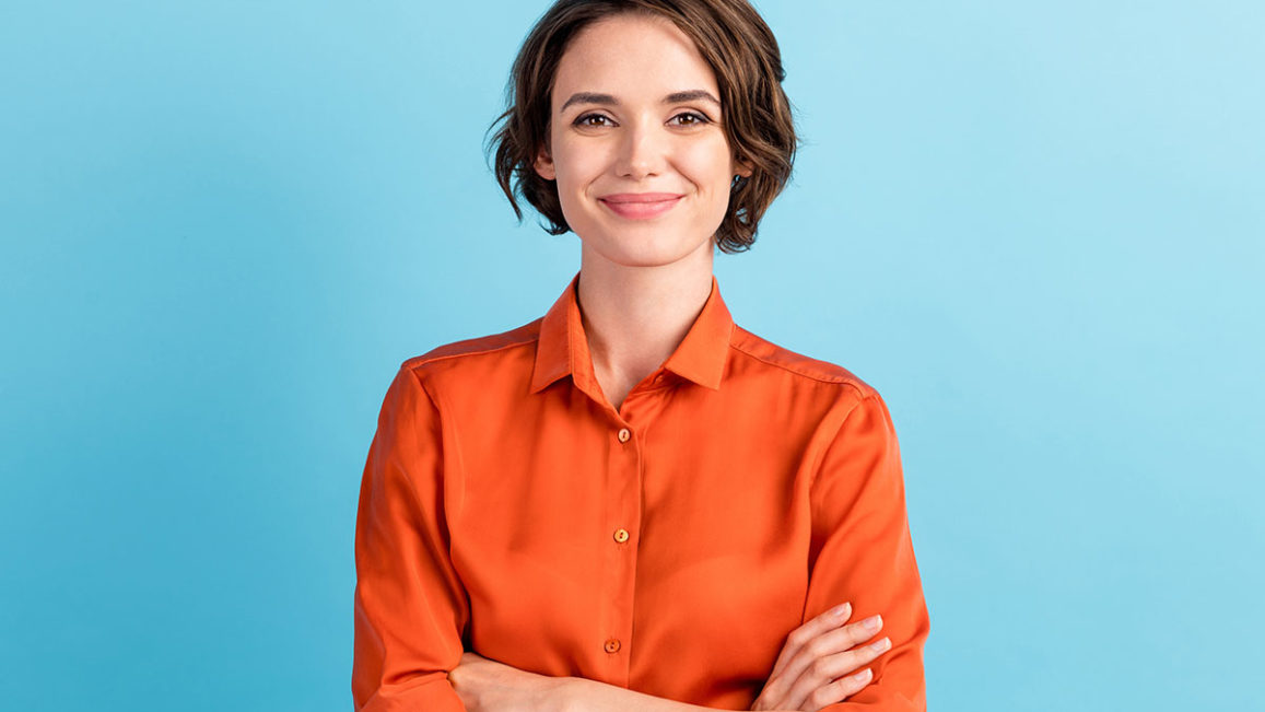a woman smiling and looking confident after struggling with feeling self-conscious