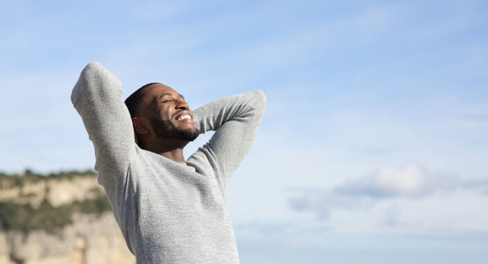 a happy man stands outside with his arms around his neck embracing national nutrition month